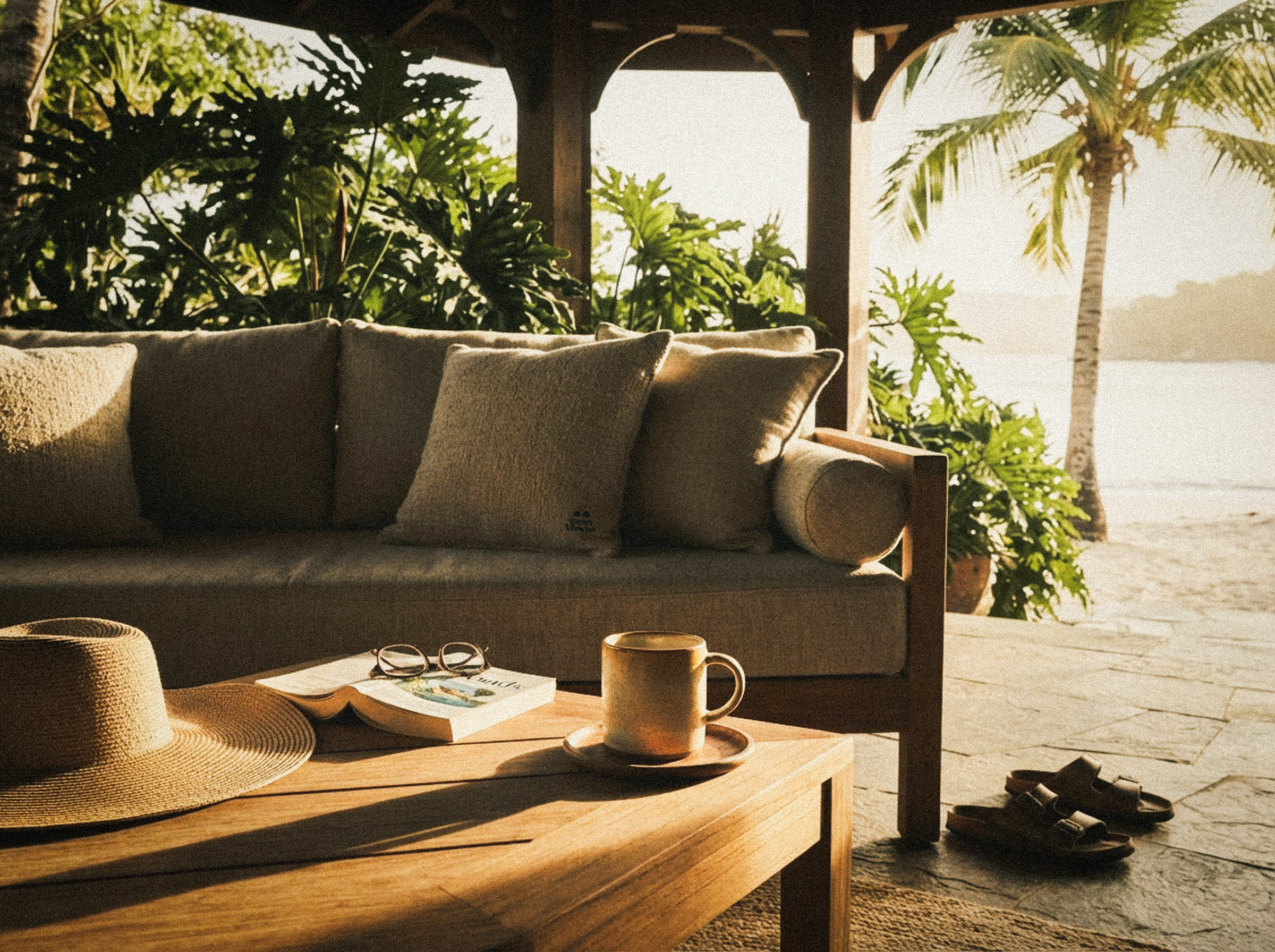 A wraparound deck with a low sofa and a private plunge pool tucked beneath a thatched roof.